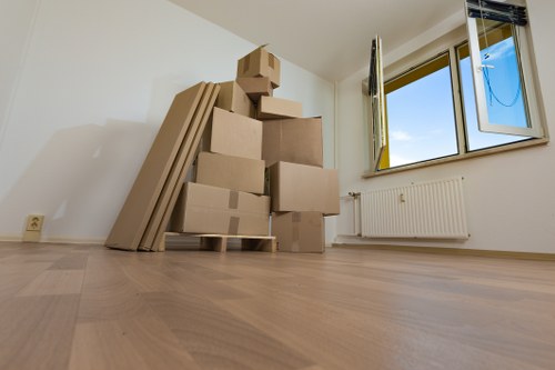 Staff member trained in safe lifting while handling furniture on a move