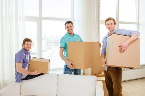 Professional movers carrying boxes through central London