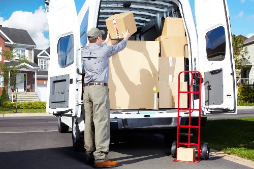 Furniture being carefully moved through a narrow staircase